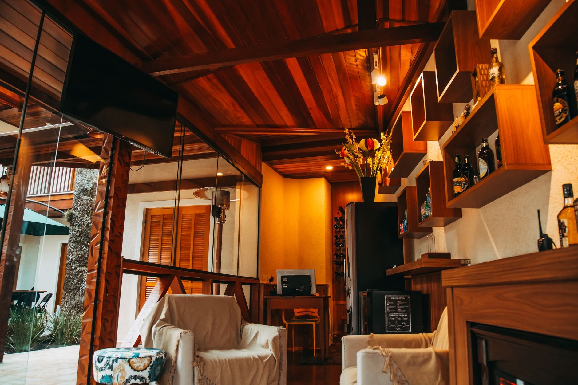 Warm and inviting living room showcasing modern wooden decor and a comfortable armchair setup.